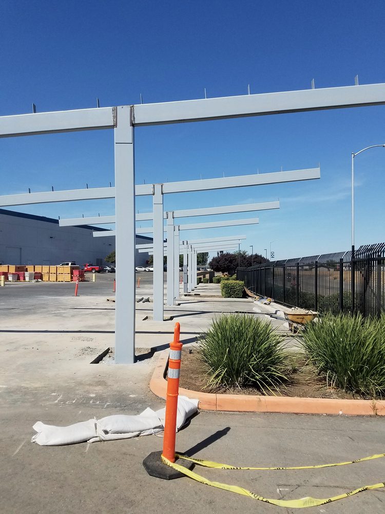 Row of steel frames for solar shade structures over parking