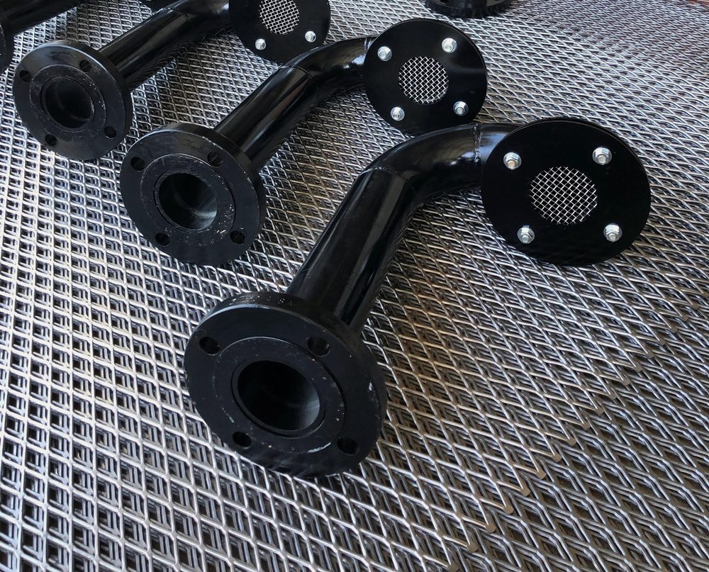 Black powder-coated flanged pipe fittings with screens on expanded steel grating