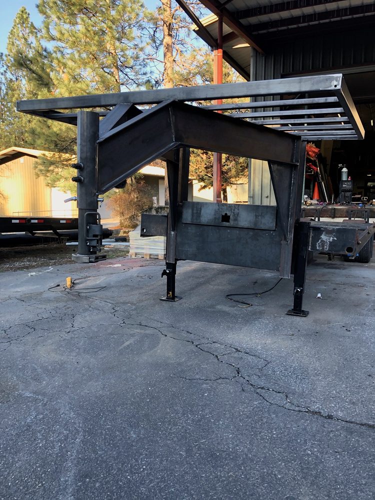Steel gooseneck trailer frame and headache rack fabricated outside the shop